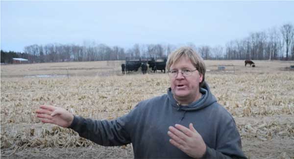 Farmer standing in farm field talking