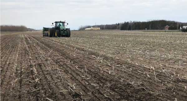 Tractor in bare farm field