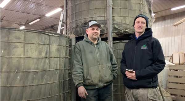 Two men standing in farm shop
