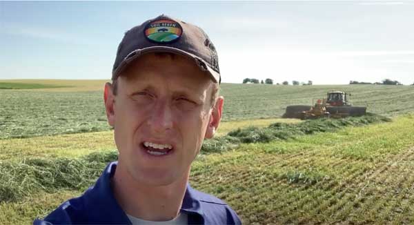 Man talking to camera in farm field