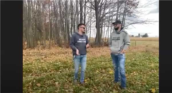 Two men talking in farm field