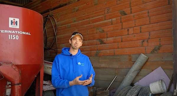 Man talking in equipment shed