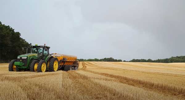 Tractor in brown farm field
