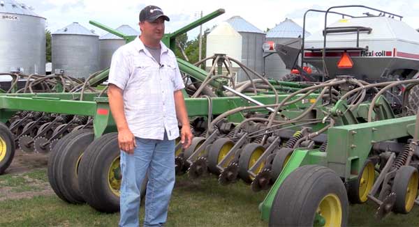 Man standing in front of seeder