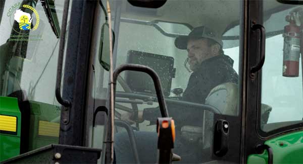 Farmer sitting in a tractor cab