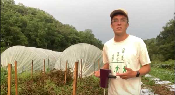 Man standing in front of hoop houses
