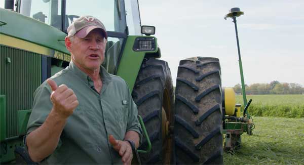 Farmer standing in front of a tractor