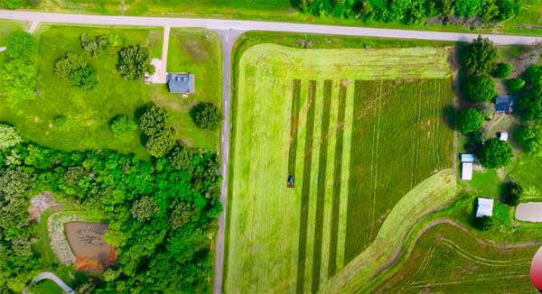 Aerial photo of roller crimping in a farm field