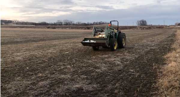Planter planting seed in farm field