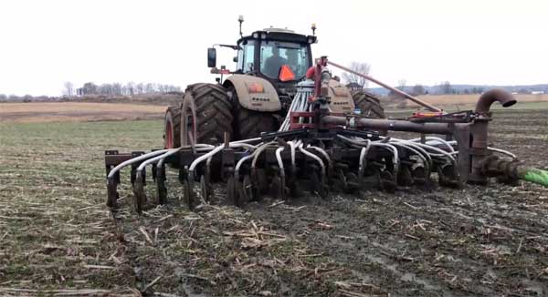 Tractor injecting manure into soil