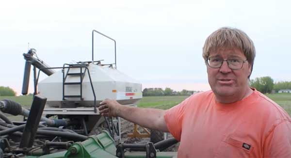 Farmer pointing to strip till planter