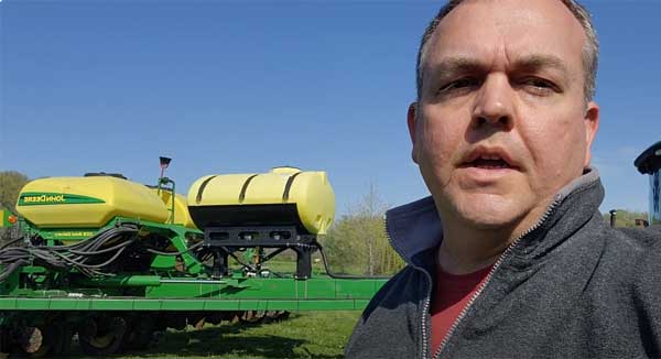 Man talking to camera with planter in background