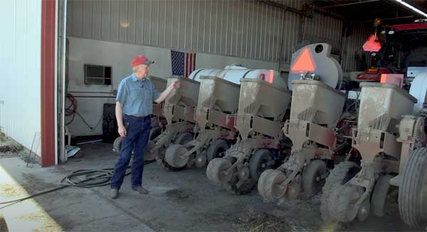Farmer standing in front of strip tiller