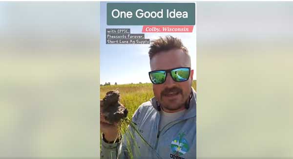 Man holding up clump of soil