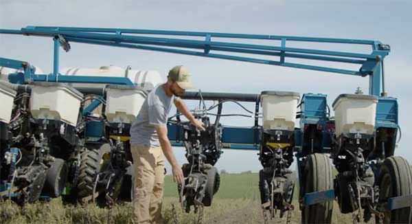 Man demonstrating planting equipment