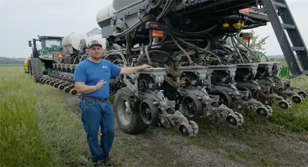 Man standing with planting equipment