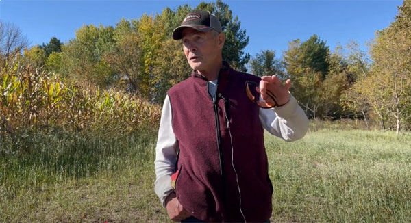 Landowner talking to camera from a farm field