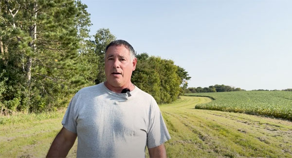 Farmer talking to camera from farm field
