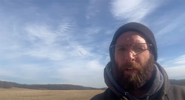 Farmer talking into the camera from a farm field