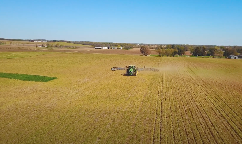 Planter planting cover crops in a farm field