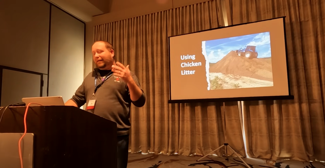 Man standing at a podium giving a talk