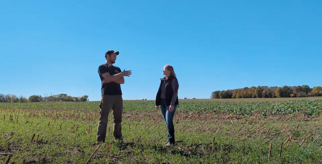Man and woman talking in farm field